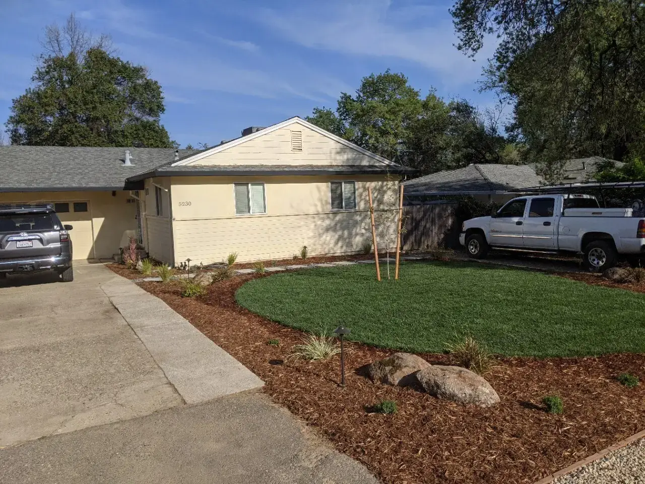 Front yard design with paver walkway and planting beds