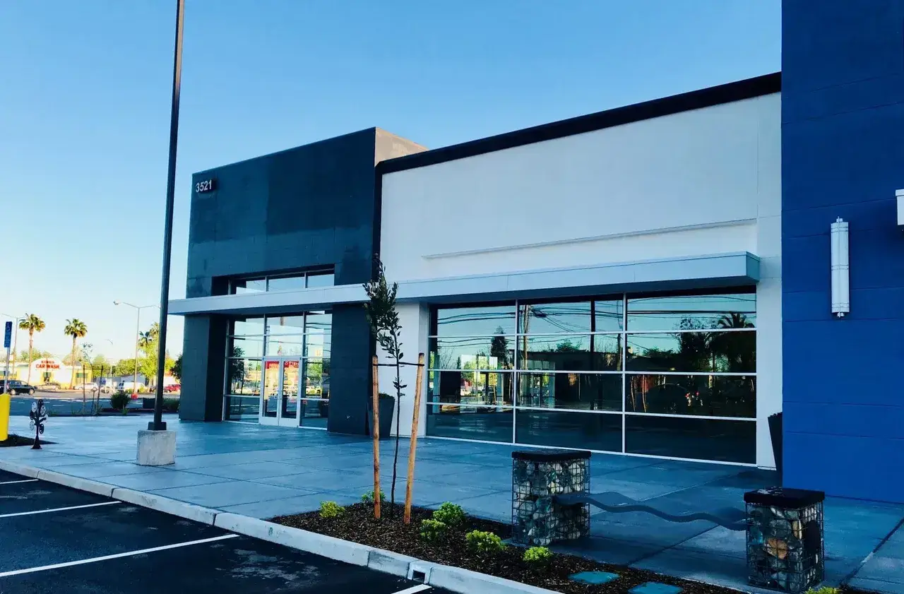 Corner-lot commercial landscape with curb and planters