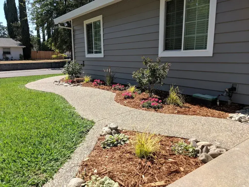 Planter beds in front of a home with fresh mulch